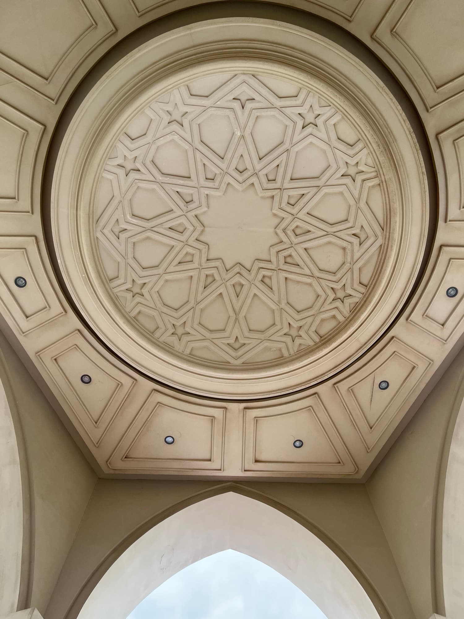 A carved ceiling medallion of interlocking star geometry.