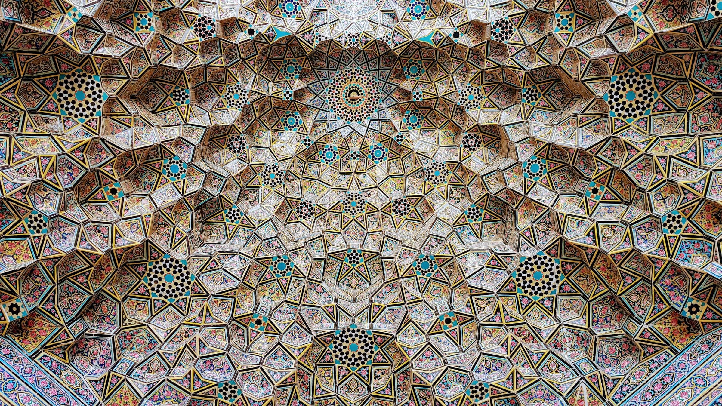 A muqarnas vault faced in glazed tilework.